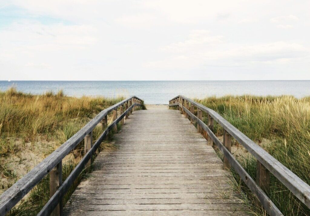 photo of gray wooden bridge